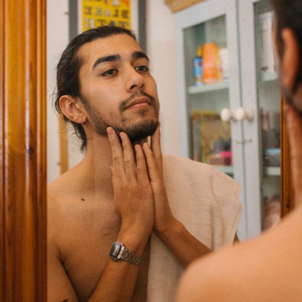 man looking in bathroom mirror