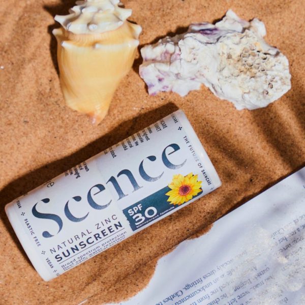 natural zinc sunscreen in the sand with shells