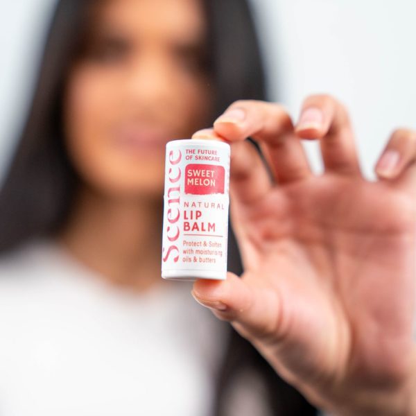 woman holding sweet melon lip balm