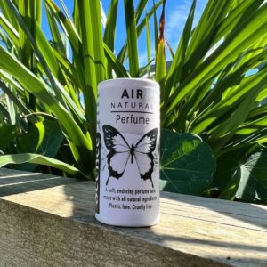 Natural perfume balm in front of plant, air