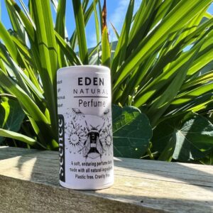 Natural perfume balm in front of plant, Eden