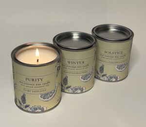 3 candles in tin with one lit