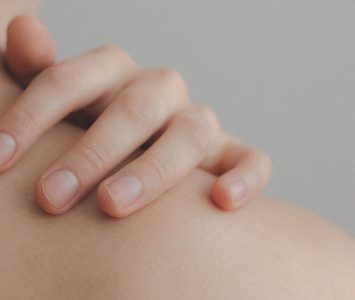 Close Up Photo Of Person Touching Their Shoulder 1727200