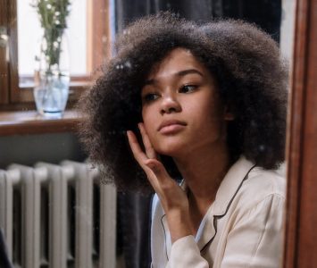 Woman using skincare in the mirror