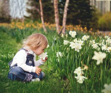 Natural Skincare for Spring - child smelling daffodil